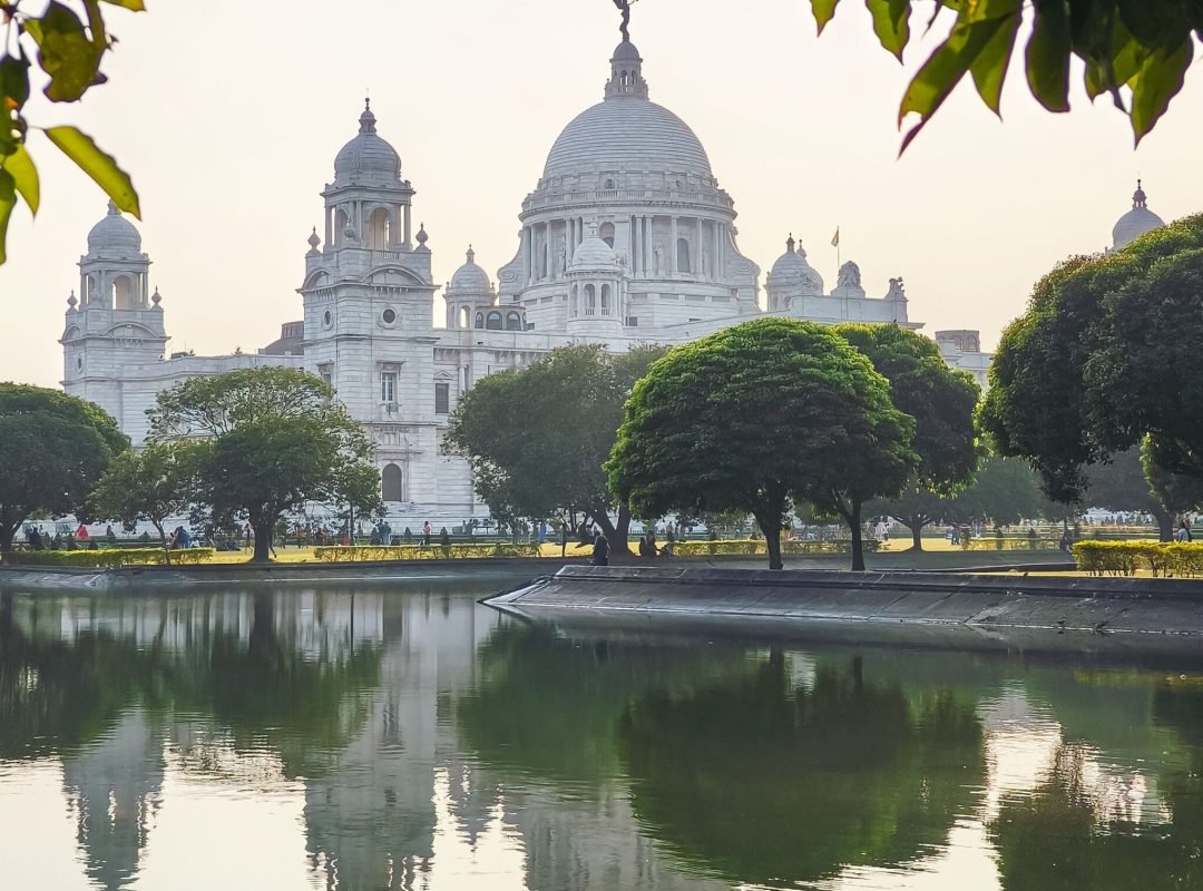 Scenic view of the Victoria Memorial in Kolkata, showcasing its reflection in a calm pond.