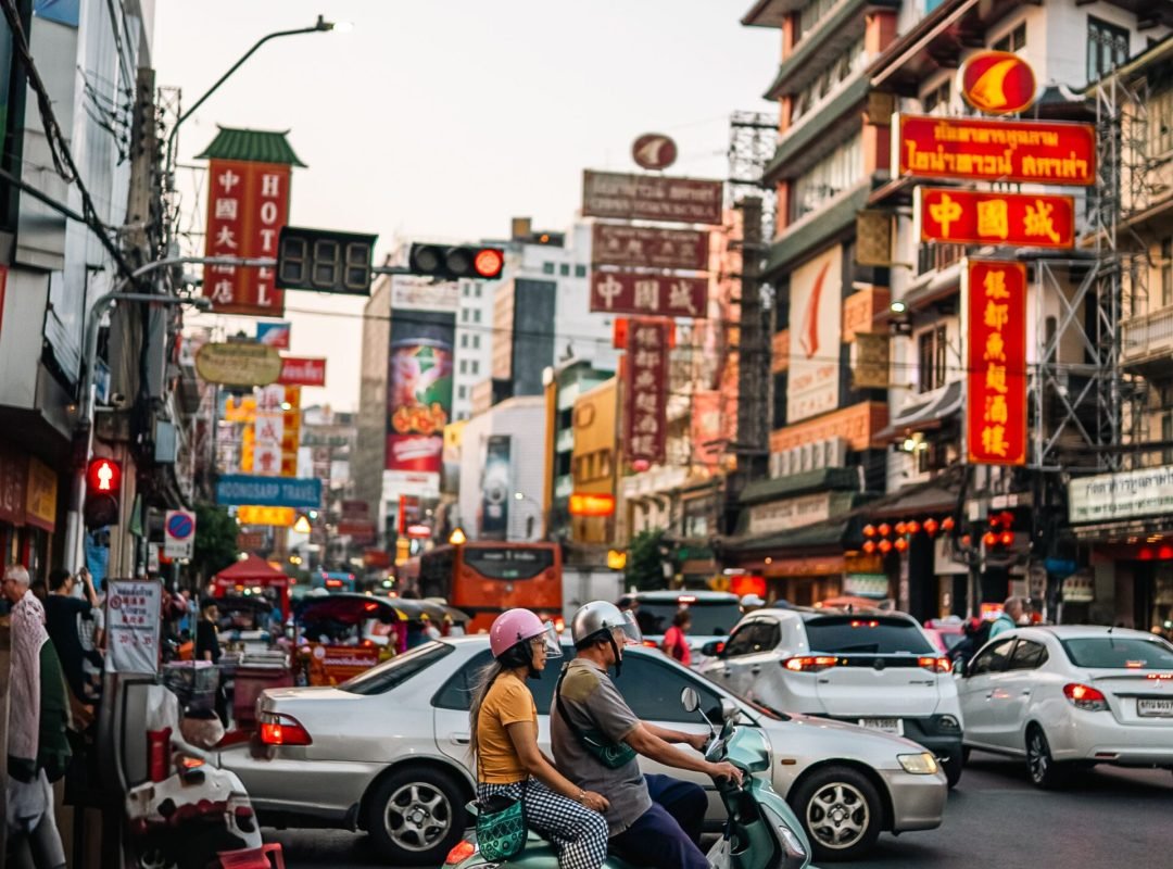Lively night scene in Bangkok's Chinatown showcasing bustling street life and vibrant signs.